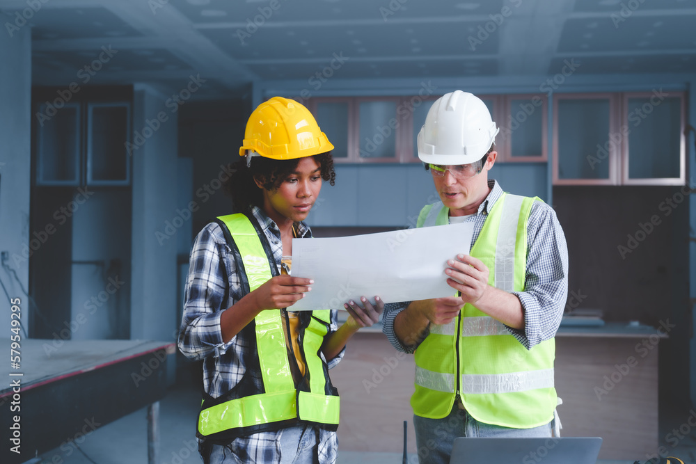 Wall mural Group of multi ethnic engineer construction site worker meeting at workplace, Architects working together at construction site to remodeling home or building.