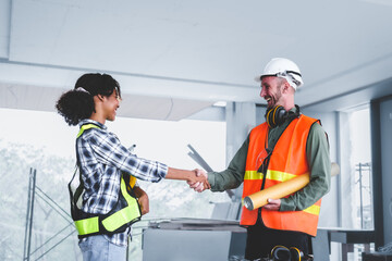 Group of multi ethnic engineer construction site worker meeting at workplace, Architects working together at construction site to remodeling home or building. Shaking hands