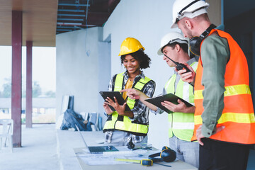 Group of multi ethnic engineer construction site worker meeting at workplace, Architects working together at construction site to remodeling home or building. Working with laptop and tablet pc