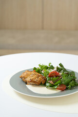 grilled chicken caesar salad on table