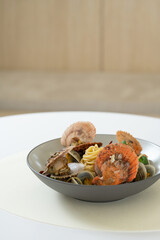 scallops vongole pasta on table