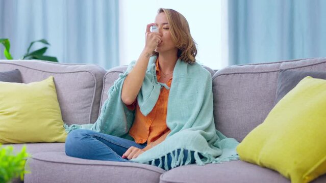 Asian woman, sick and chest pain, health and asthma, virus from bacteria, cold or flu with lung illness at home. Healthcare, medicine and young female sitting on couch, breathing problem and inhaler