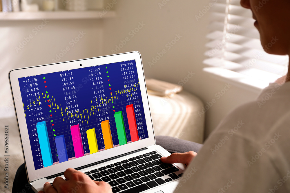 Poster man analyzing situation on stock exchange market via laptop, closeup. data and graph on screen