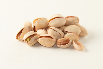Pile of pistachios isolated on white background.