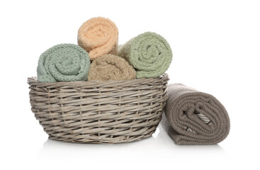 Fototapeta na wymiar Wicker basket with rolled towels on white background