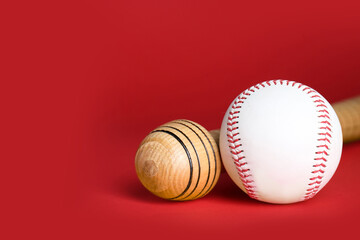 Wooden baseball bat and ball on red background, closeup. Space for text