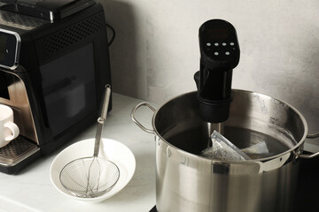 Sous vide cooker and vacuum packing in pot. Thermal immersion circulator