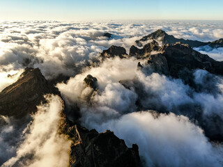 Mountain peaks peek out from the clouds.
