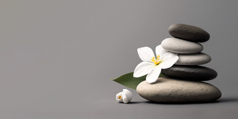 Naklejka na ściany i meble Zen pebble stones and white flower on gray background. Generative AI