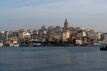Fototapeta na wymiar View of the Beyoglu district in Istanbul and the Galata Tower from the waters of the Golden Horn Bay on a sunny day, Istanbul, Turkey