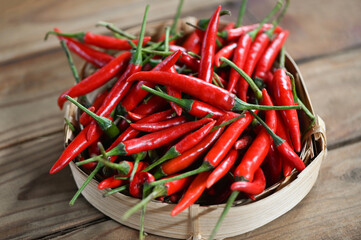 Chili pepper, Red hot chilli peppers on basket background. Close up group of ripe red chilli