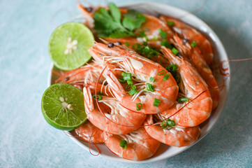 shrimp on white bolw and wooden background dining table food, Fresh shrimps prawns seafood lemon lime with herbs and spice, top view