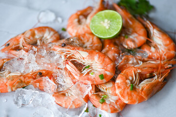shrimp on seafood plate and wooden background dining table food, Fresh shrimps prawns  lemon lime with herbs and spice