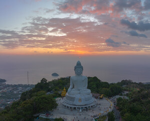 aerial view Phuket big Buddha in beautiful sunset..the sun shines through the clouds impact on ocean surface.The beauty of the statue fits perfectly with the charming nature..cloud scape background..