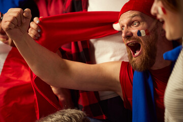 Bearded man, football, soccer fan emotionally cheering up favourite france team. People wearing country's attributes, scarves and paints. Concept of sport, cup, world, team, event, competition