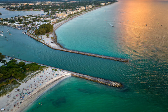 Aerial evening seascape with Nokomis sandy beach in Sarasota County, USA. Many tourists enjoing summer vacation time swimming in warm Mexico gulf water and sunbathing on hot Florida sun
