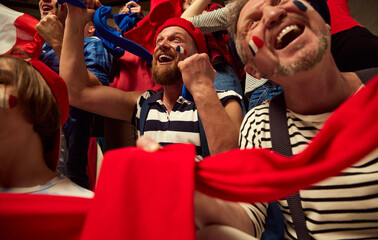 United. Football, soccer fans emotionally cheering up favourite france team. People wearing...