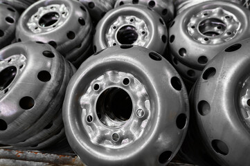 Stacks of new metal stamped wheel disks in plant warehouse
