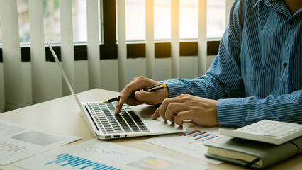 Businessman typing on laptop keyboard working on home finance related to taxes and expenses