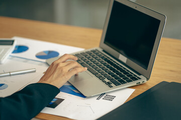 Businessman typing on laptop keyboard working on home finance related to taxes and expenses