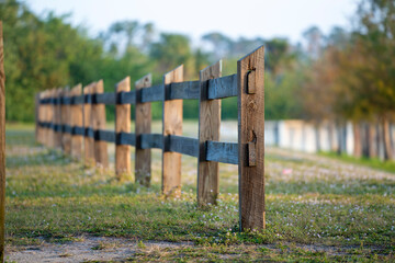 Wooden fence barrier at farm grounds for cattle and territory protection