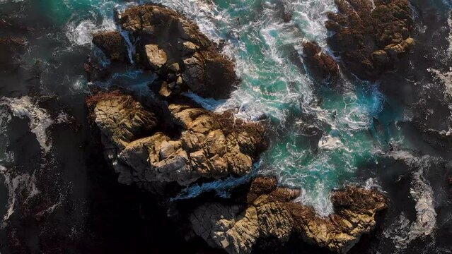 Beautiful top down view of waves crashing over rocks in northern california, Big Sur.