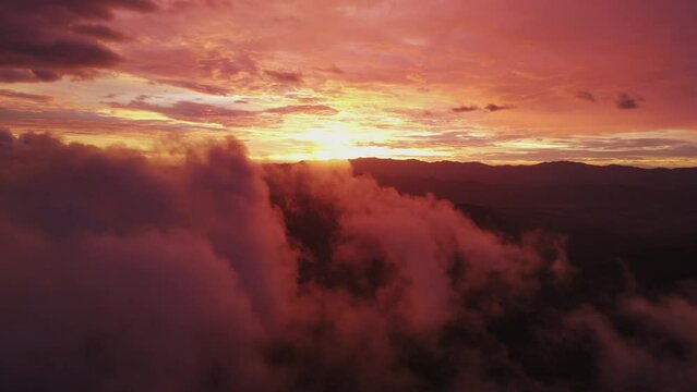 Bright Red Sky And Sun At Sunset With Mist And Fluffy Cloud Foreground, 4K Drone
