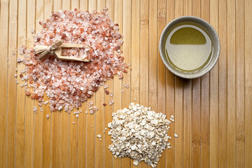 Flatlay photo of Himalayan sea salt, scoop, oats, and olive oil.