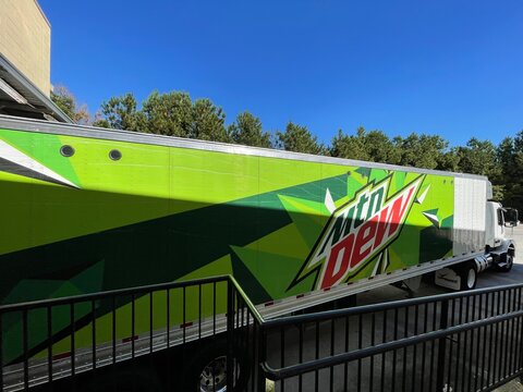 Grocery store Mtn Dew semi truck delivering at a dock