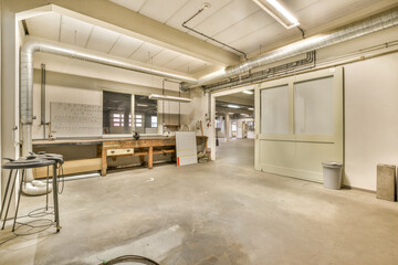 the inside of a building that is being used as a workshop for metal fabrications, with tools and...