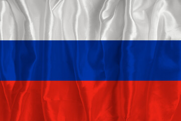 The flag of Russia on a silk background is a great national symbol. Texture of fabrics The official state symbol of the country
