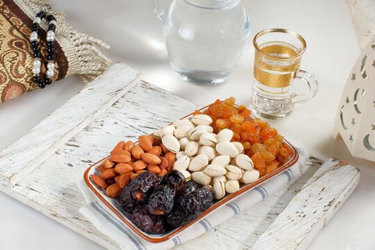 dates fruit,golden raisin,almond,pistachio,and mineral water.traditional Ramadan, iftar meal. Ramadan kareem fasting month concept