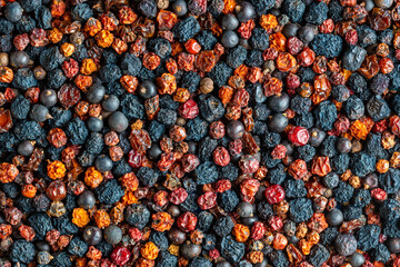 Homemade dried wild berries in background, closeup, top view. Food background. Healthy food, mix of colorful dry berry