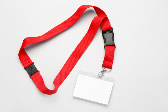 Blank badge with red lanyard on light background