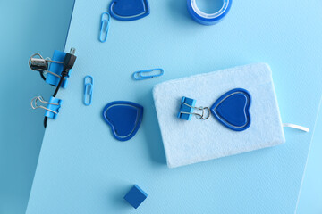 Set of stationery and USB cable on color background, closeup