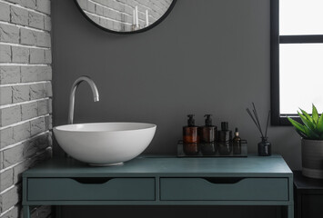 Naklejka na ściany i meble Table with sink and bath accessories in modern bathroom