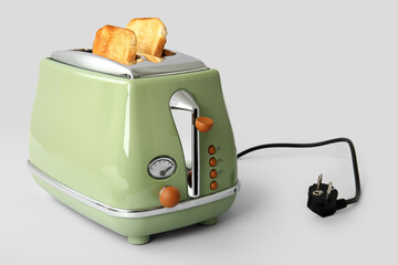 Modern toaster with crispy bread slices isolated on white background