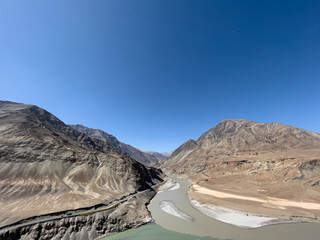 Sangam, Confluence of Zanskar and Indus river near Leh Ladakh, India shows its 2 color during...