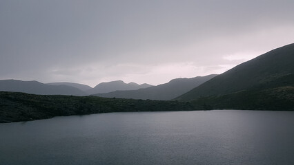 The rugged beauty of the northern mountains. A beautiful lake in the mountains. Tranquil water surface