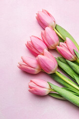 Bouquet of pink tulips on pink background.