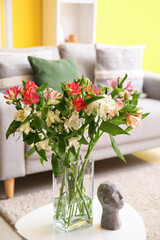 Interior of living room with alstroemeria flowers on table