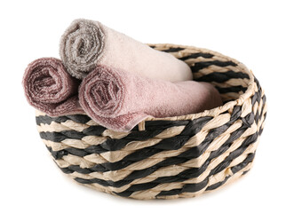 Basket with rolled soft towels isolated on white background