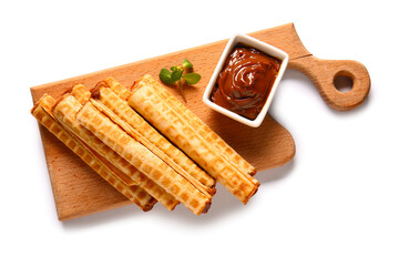 Board with delicious wafer rolls, boiled condensed milk and mint isolated on white background
