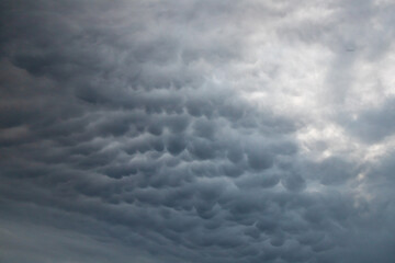 Unique rare phenomenon of mammatus cloud formation over Glass House Mountains National Park during spectacular sunset. Weather phenomena in Queensland, Australia