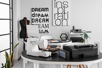 Interior of modern atelier with tables and mannequin