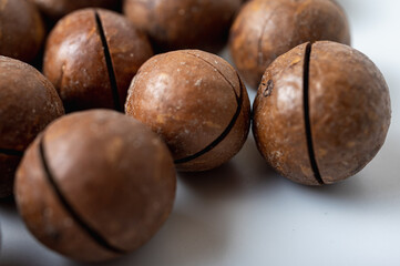 light background, macadamia nuts close-up on a light surface, tasty nut healthy nutrition, food.
