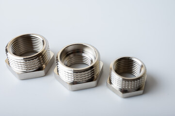 brass metal tee water adapters isolated on light background close up plumbing connections and details