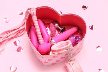 Fototapeta Gift box with sex toys and confetti on pink background obraz