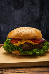 Homemade hamburger on a wooden table.