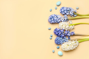 Beautiful hyacinth flowers and Easter eggs on beige background